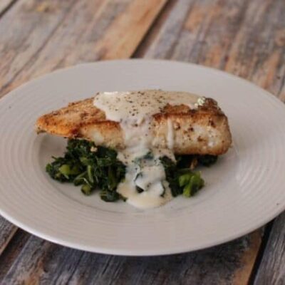 a halibut fillet on spinach
