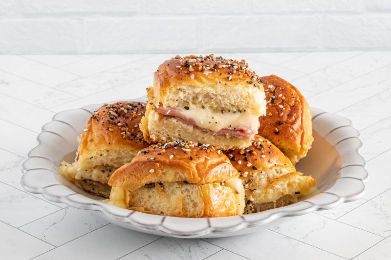 baked ham and cheese sliders with everything bagel seasoning in a bowl