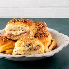 Buttery, filled biscuits topped with seasoning and herbs.