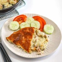 Baked chicken pot pie served with fresh sliced tomatoes and cucumbers.