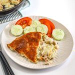 Creamy potato casserole with baked pie and fresh vegetables.