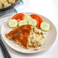 Creamy potato casserole with baked pie and fresh vegetables.