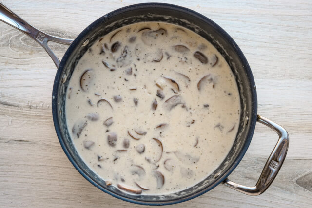 Creamy sauce with mushrooms and ham for ham tetrazzini.