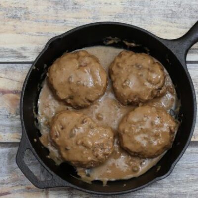 Overhead photo of hamburger steaks with gravy.