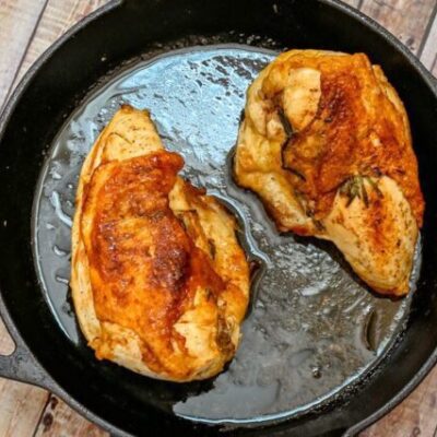 herb roasted split chicken breasts in a cast iron pan