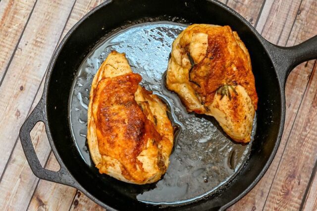 herb roasted split chicken breasts in a cast iron pan