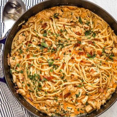 Creamy chicken and pasta stir-fry with herbs and spices.