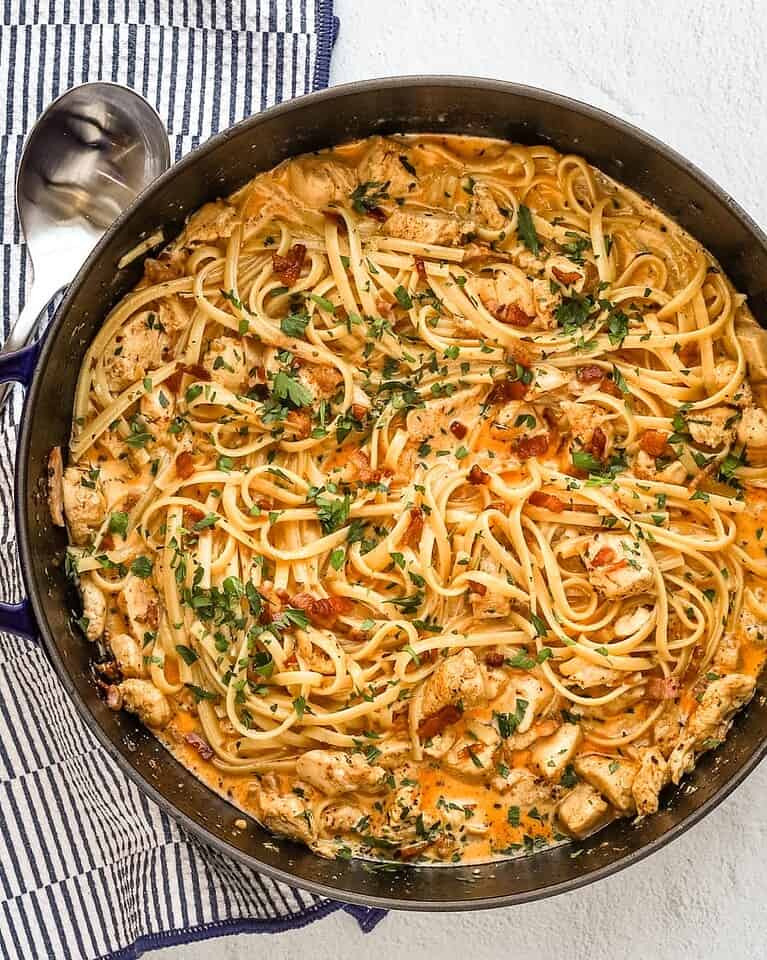 Creamy chicken and pasta stir-fry with herbs and spices.