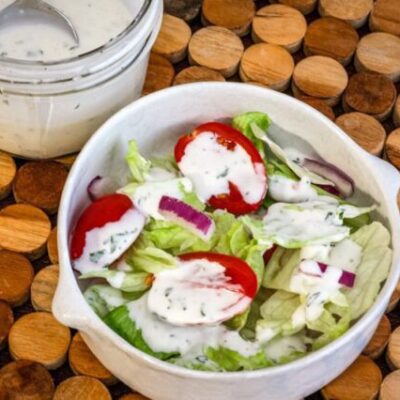 homemade buttermilk dressing drizzled on a tossed salad