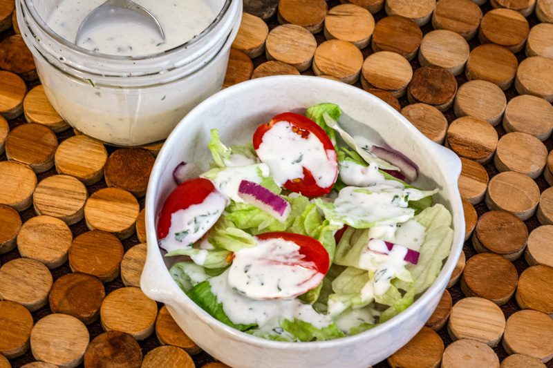 homemade buttermilk dressing drizzled on a tossed salad