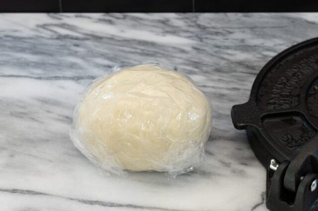Tortilla dough wrapped in plastic.