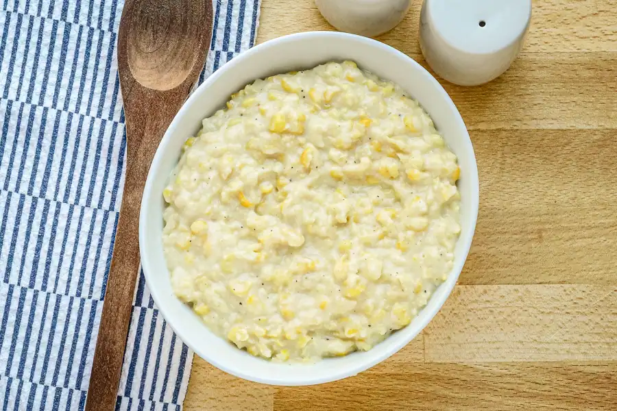 A serving dish of homemade cream style corn.