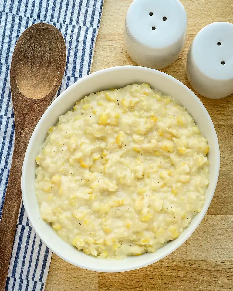 Creamy potato salad with chopped eggs and black pepper.