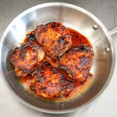 glazed honey garlic chicken thighs in a skillet