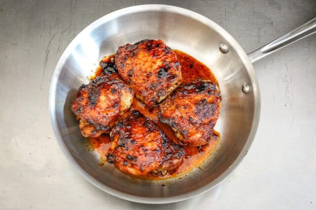 glazed honey garlic chicken thighs in a skillet