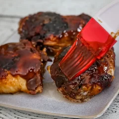Glazed meatballs on a baking sheet.