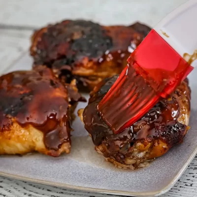 Glazed meatballs on a baking sheet.