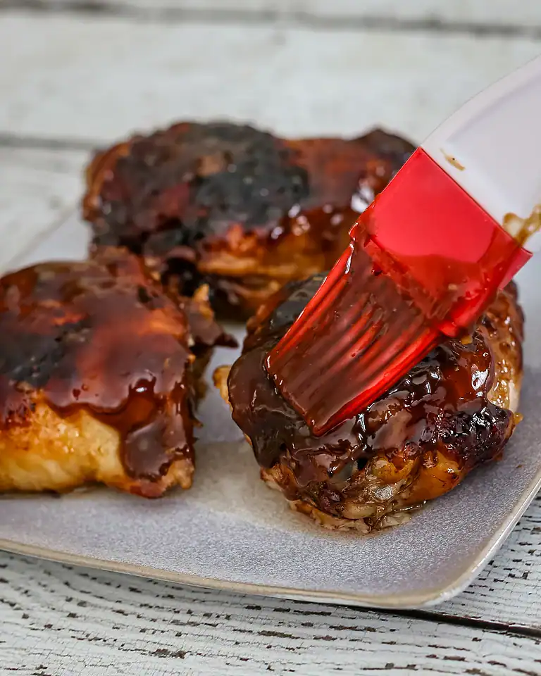 Glazed meatballs on a baking sheet.