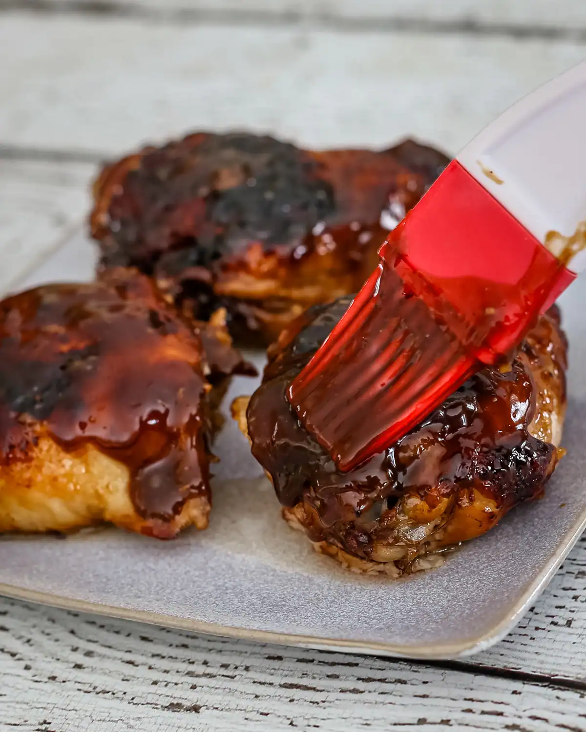 Glazed meatballs on a baking sheet.