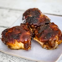 Sweet and savory glazed chicken meatballs on a plate.