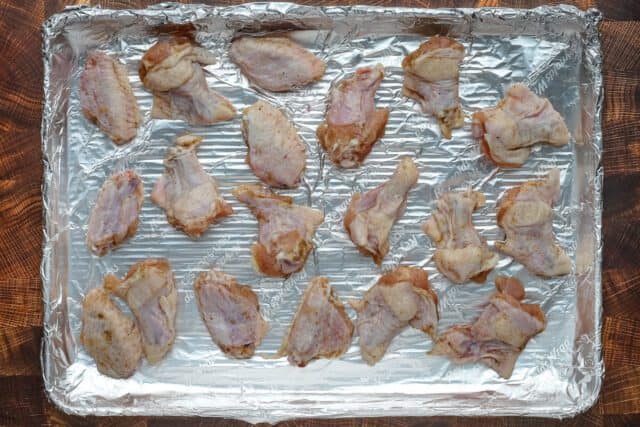 Hot honey chicken wings preparation: chicken wings on a foil lined baking pan.