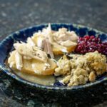 hot turkey sandwich with cranberry sauce, stuffing, and gravy