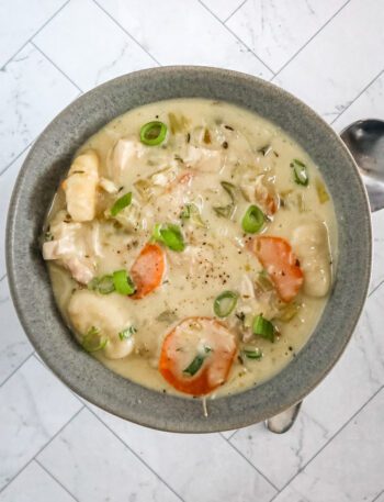 Chicken and dumpling soup with gnocchi dumplings, vegetables, and a creamy chicken broth.