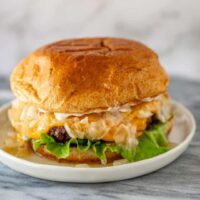 A Wisconsin butter burger with cheese, onions, and lettuce.