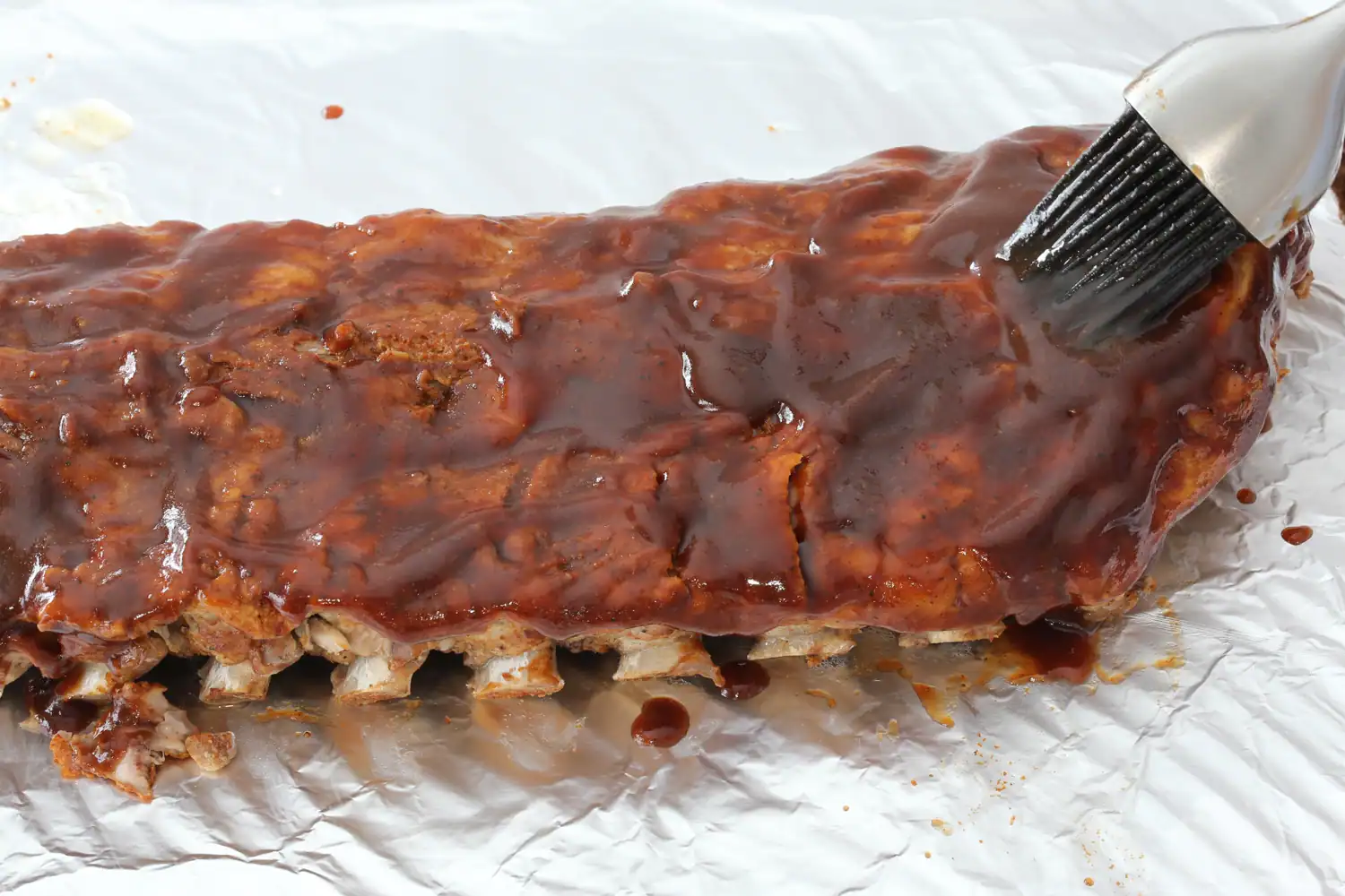Brushing sauce on ribs.