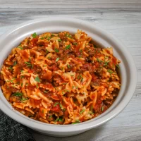 Baked pasta with ground beef and tomato sauce.