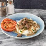 instant pot beef tips served over mashed potatoes with gravy