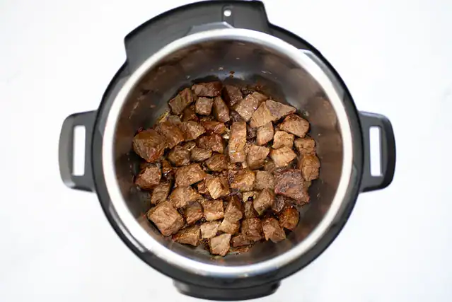 Beef cubes browning in the Instant pot for beef tips.