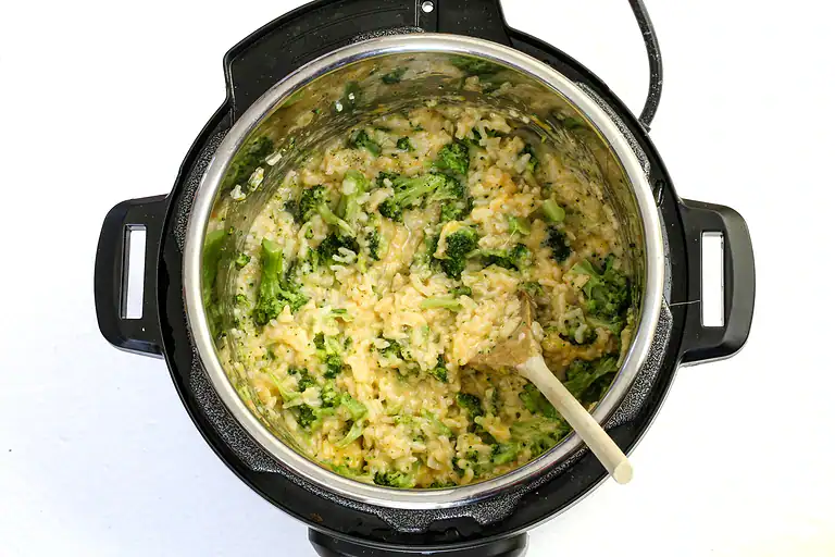 Cooked broccoli and rice mixed in an instant pot.