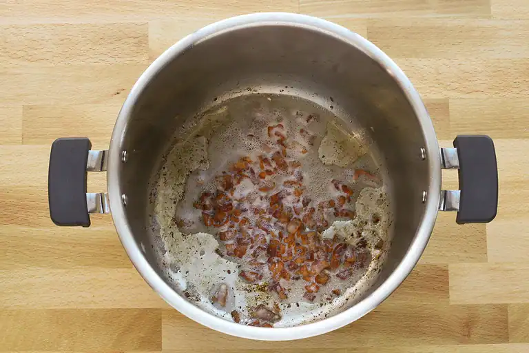 Sautéed onions and garlic in a stainless steel pot.