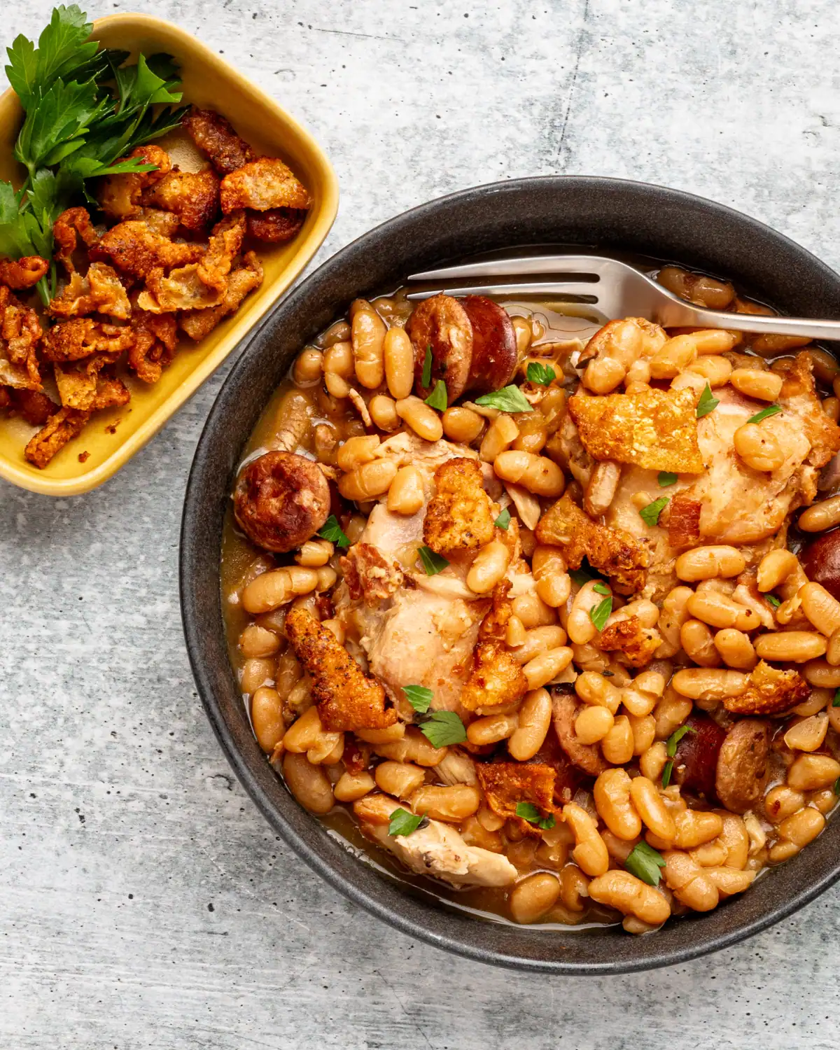 Baked chicken with white beans and sausage in a savory broth.
