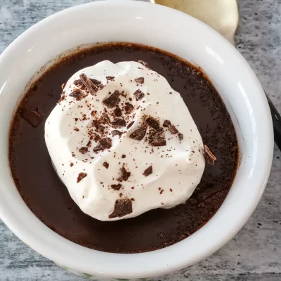 Creamy hot chocolate topped with whipped cream and chocolate shavings.