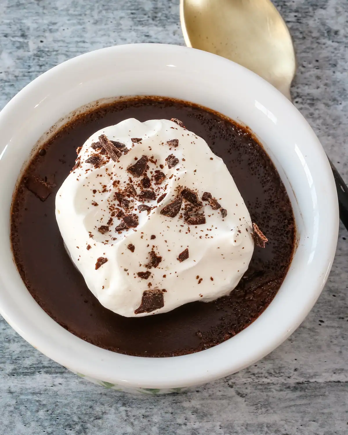 Creamy hot chocolate topped with whipped cream and chocolate shavings.