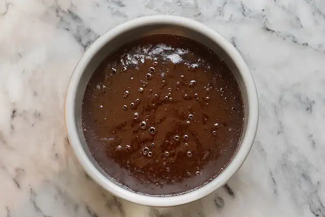 Pressure cook the cake in the pan, then remove from the pot.