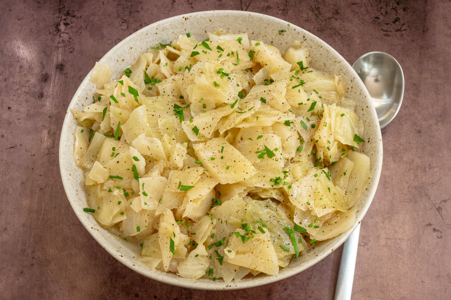 Instant Pot cooked cabbage, garnished with parsley.