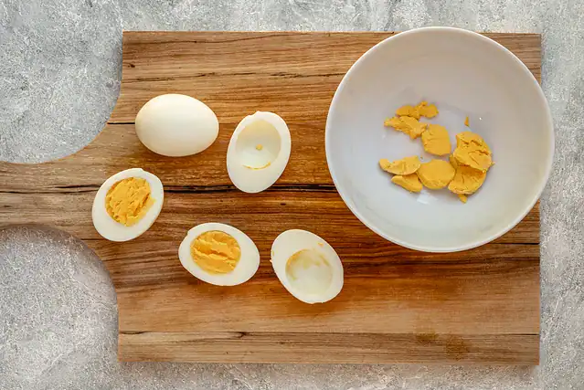 Slicing and separating the yolks to make Instant Pot deviled eggs.