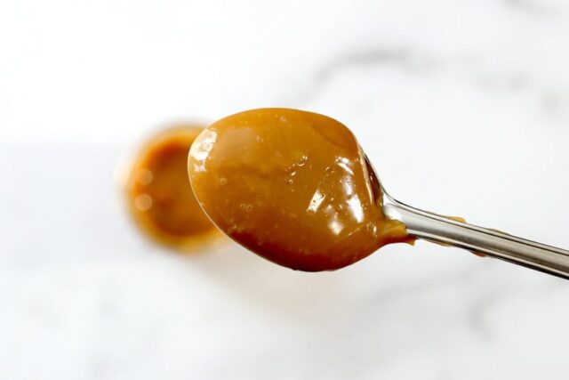 thick, rich dulce de leche on a spoon