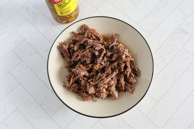 instant pot italian beef for sandwiches, shredded in a bowl