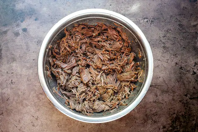 The beef is shredded for the Instant Pot Italian beef sandwiches.