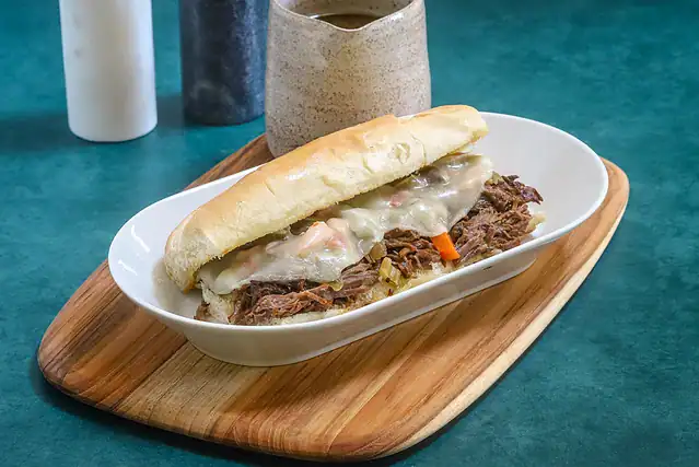 An Italian beef sandwich with giardiniera and provolone, cooked in the Instant Pot pressure cooker.