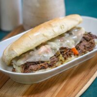 Instant Pot Italian beef sandwich with provolone and giardiniera, ready to eat.
