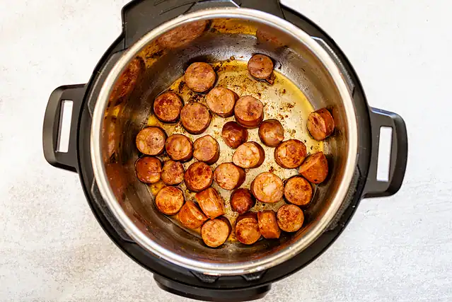 Smoked sausage is sautéed in the Instant Pot.