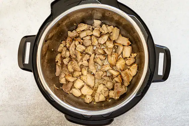 Chicken is sautéed in the Instant Pot.