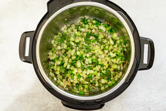 Diced onions, celery, and bell peppers in the Instant Pot.