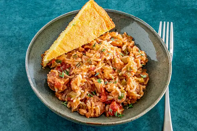 A serving bowl of Instant Pot jambalaya with chicken and spicy sausage.