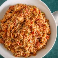 A serving bowl of Instant Pot jambalaya with chicken and spicy sausage.
